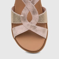 Close-up of a pink metallic and gold HP Ladies Comfort Sandal with criss-cross straps, showing textured details and a soft