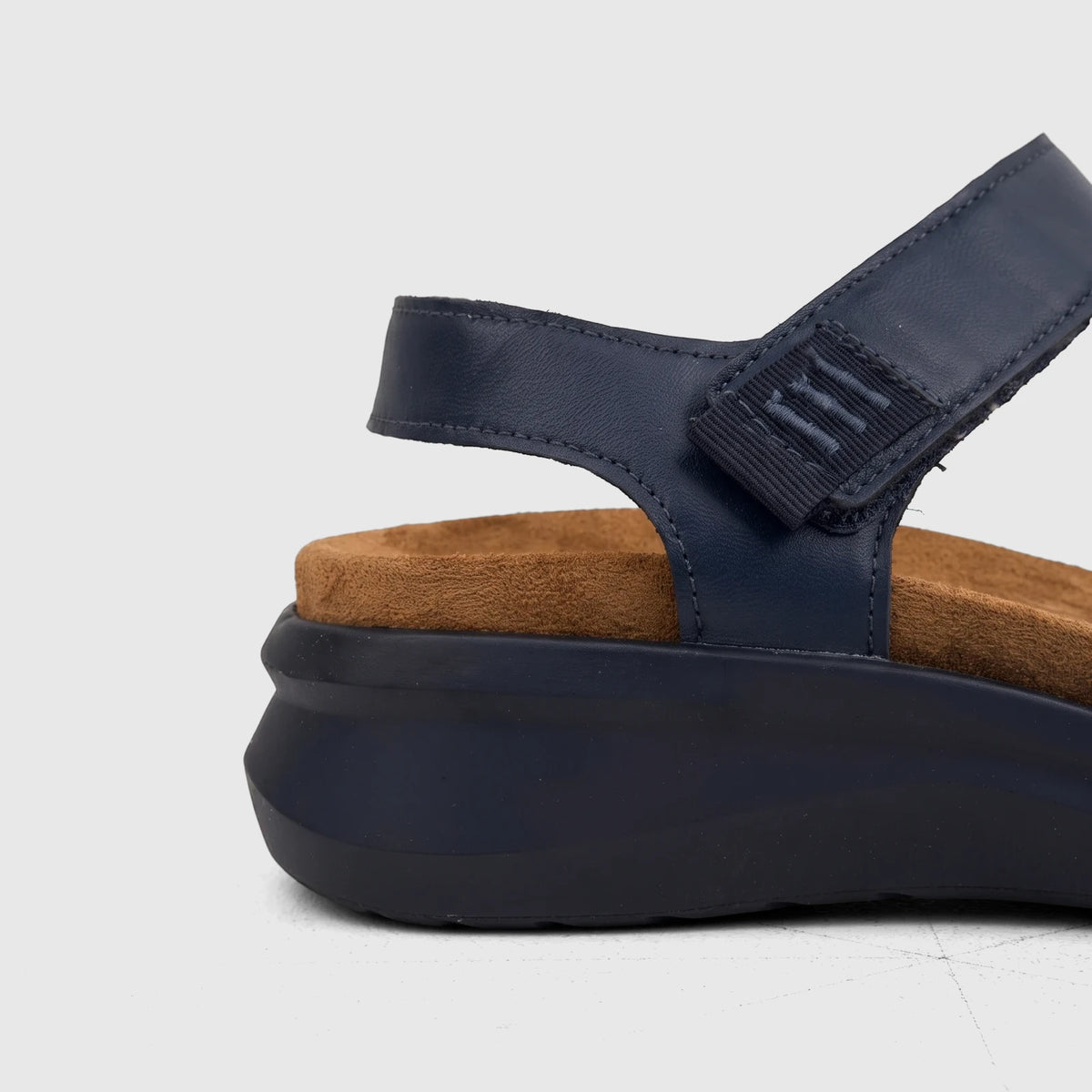Side view of an HP Ladies Comfort Sandal Saria in navy, featuring a comfortable brown footbed and a secure hook-and-loop