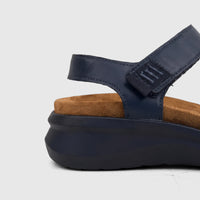 Side view of an HP Ladies Comfort Sandal Saria in navy, featuring a comfortable brown footbed and a secure hook-and-loop