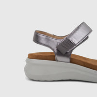 Metallic silver HP Ladies Comfort Sandal with a textured brown footbed and chunky light grey platform sole, side view.