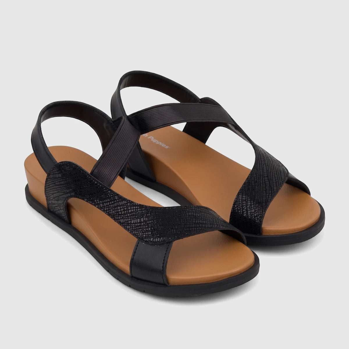 A pair of black women's comfort sandals with textured straps and a light brown wedge sole, shown from a slightly elevated