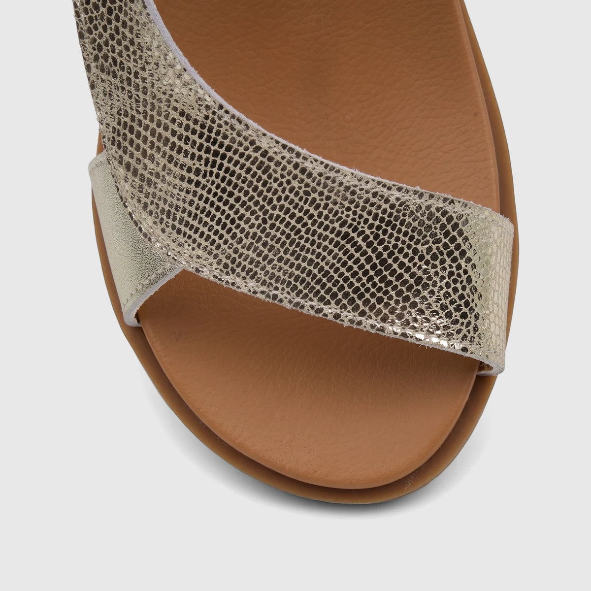 HP Zaira comfort sandal for ladies, featuring a metallic gold snakeskin-textured front strap and a comfortable tan sole.