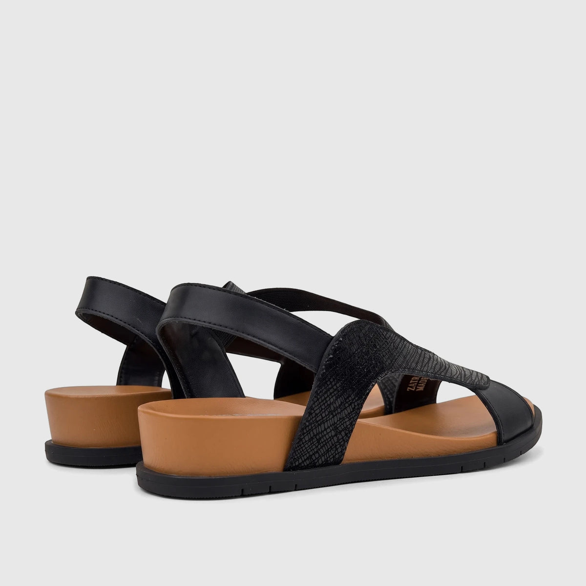 HP Ladies Comfort Sandal Zaira HPL01523 in black and tan, featuring a side view of the low platform and textured strap