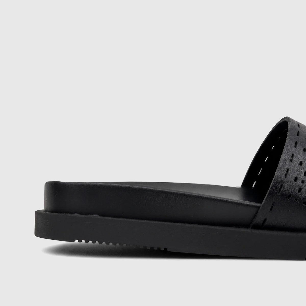 Side profile of a black HP Ladies Comfort Slide Reya sandal, featuring a thick sole and a perforated upper strap.