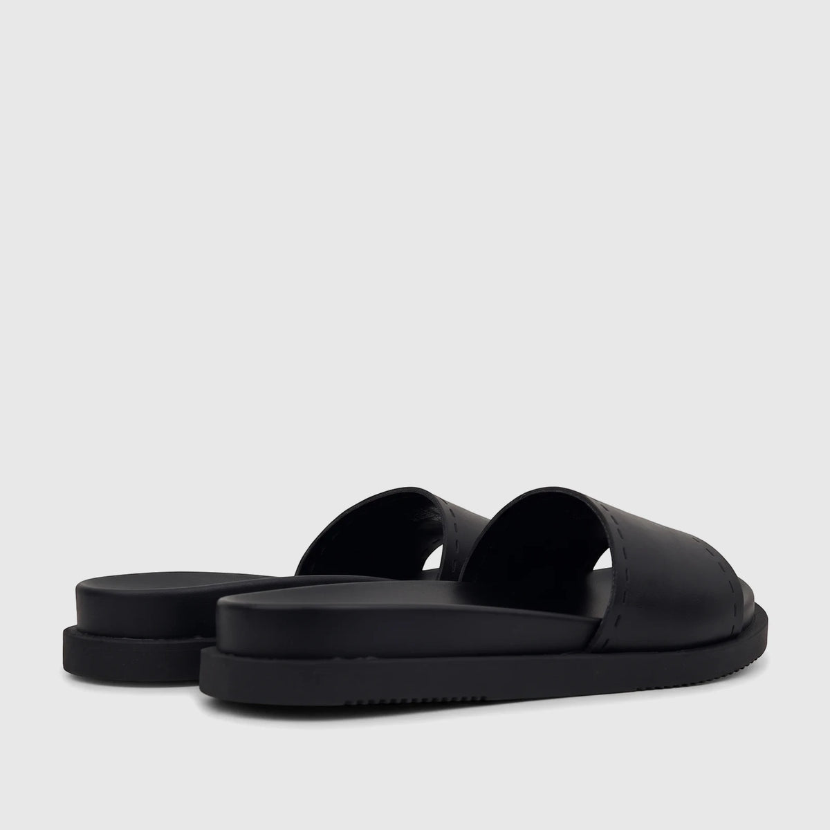 Two black HP Ladies Comfort slides, side-back view, featuring wide straps with visible stitching and thick soles.