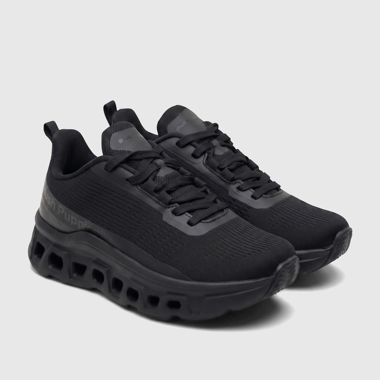 A pair of black HP Ladies Comfort Sneaker Maxene HPL01354 HL287, featuring knit uppers, prominent laces, and a chunky sole