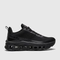 Black Hush Puppies Maxene comfort sneaker with a mesh upper and a distinctive sole design, viewed from the side.