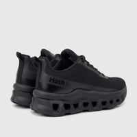 A pair of black HP Ladies Comfort Sneaker Maxene with a chunky sole, viewed from a rear-quarter angle on a white background.