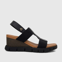 HP Ladies Comfort Wedge Sandal Nyx in black, featuring wide straps, a tan footbed, and a striped brown wedge sole from a