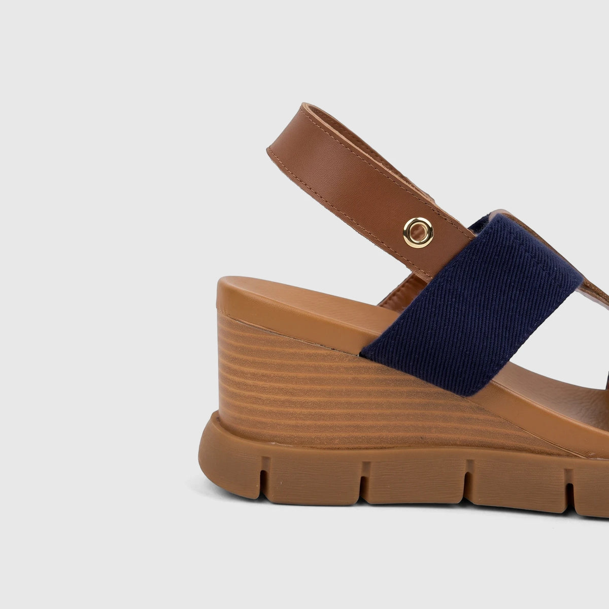 Side view of an HP Ladies Comfort Wedge Sandal featuring navy blue fabric straps, brown leather-like straps, and a brown