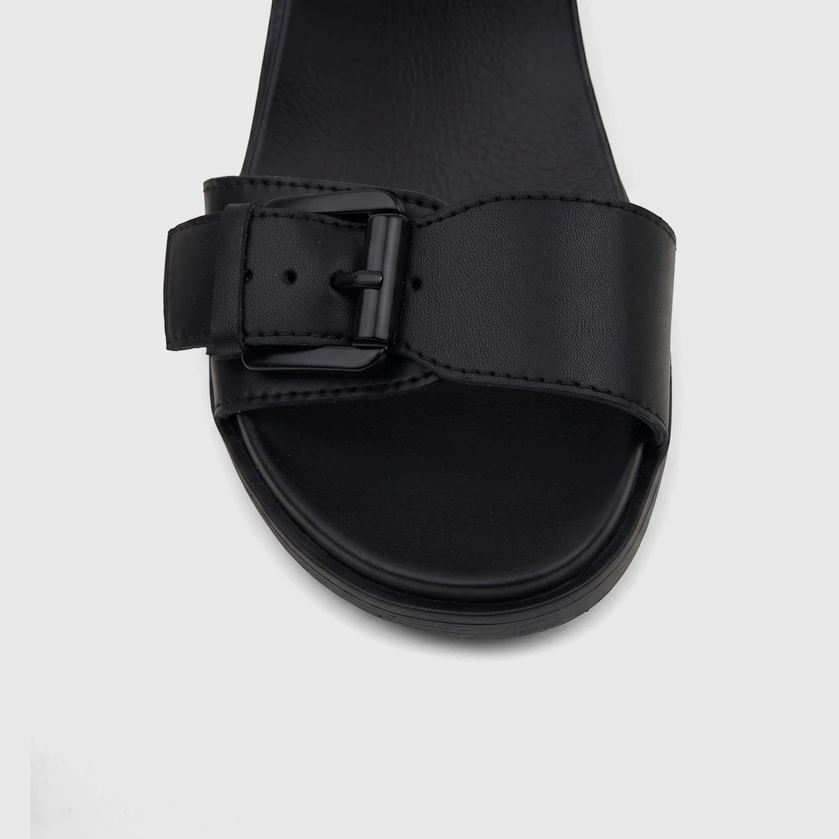 Close-up of HP Ladies Comfort Wedge Sandal Noa in black, featuring a prominent buckled strap and platform sole design.