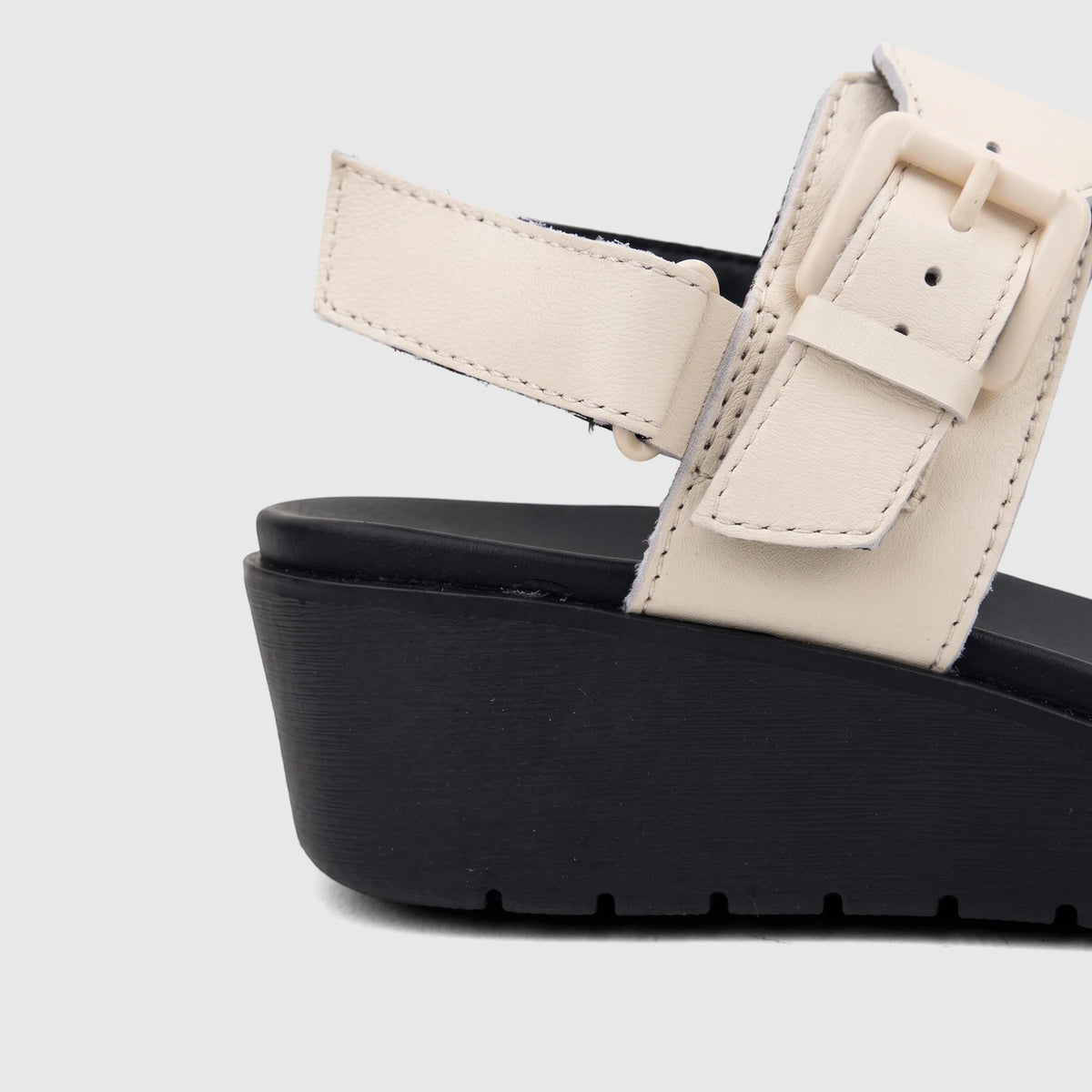 HP Ladies Comfort Wedge Sandal Noa with a cream upper, black wedge sole, and side buckle detail on a white background.