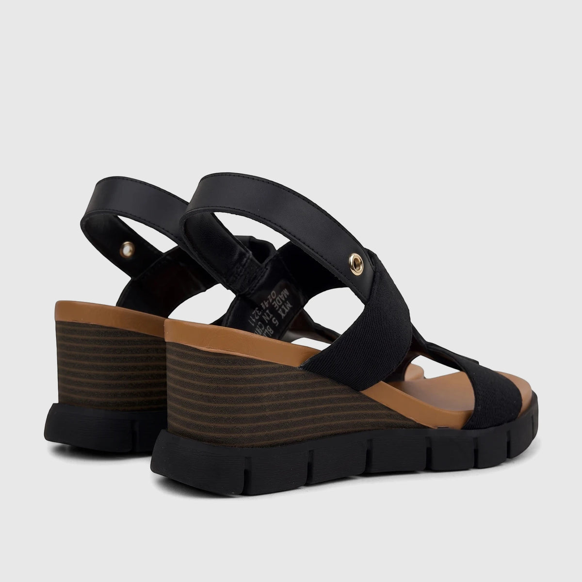 A pair of black HP Ladies Comfort Wedge Sandals Nyx HPL01515, shown from a rear-side view with tan wedge detail.