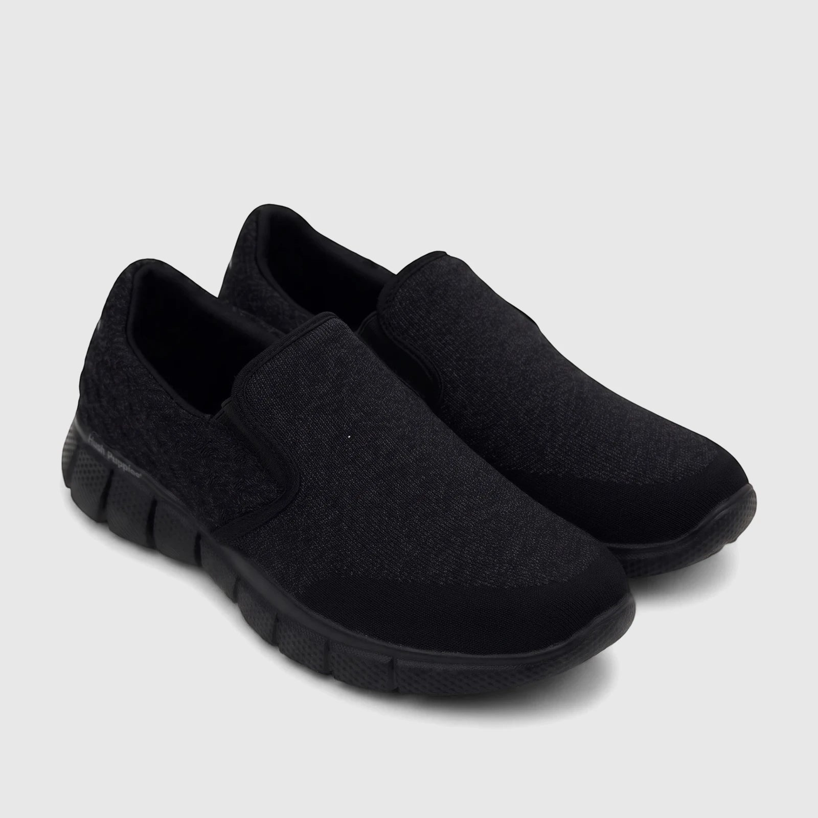 Pair of HP Men's Comfort Slip On Sneakers in black, featuring a comfortable knit texture and sturdy soles, displayed at an