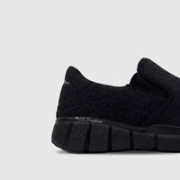 Black HP Men's Comfort Slip On Sneaker featuring a knit textile upper and a textured black sole, shown in a side view.