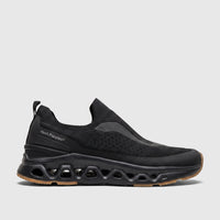 Black Hush Puppies Men's Comfort Slip-On Sneaker Knoxx. Knit upper, textured midsole with distinctive cutouts, and gum