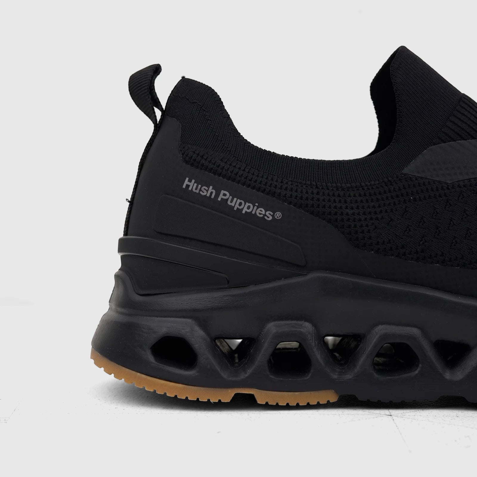 HP Men's Comfort Slip On Sneaker Knoxx in black, shown in a close-up side view highlighting its knitted upper and uniquely