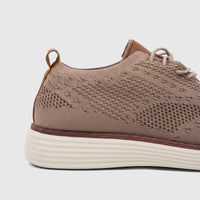 Close-up side view of an HP Men's Comfort Sneaker HPM01029 in beige Flyknit, showcasing the knit upper and textured sole.