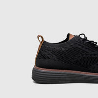 HP Men's Comfort Sneaker HPM01029 in black flyknit with brown accents, featuring a side and heel view.