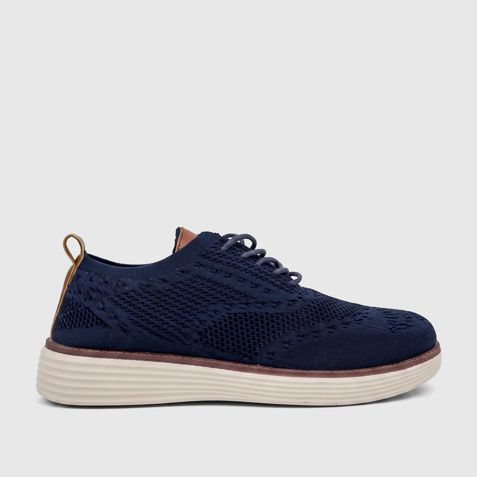 HP Men's Comfort Sneaker in navy flyknit, viewed from the side. Features dark laces, brown accents, and a textured white