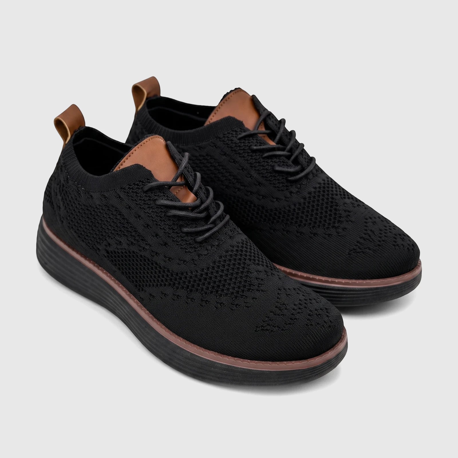 Pair of HP Men's Comfort Sneaker Styling HPM01029 black flyknit sneakers with brown accents, shown from an elevated side