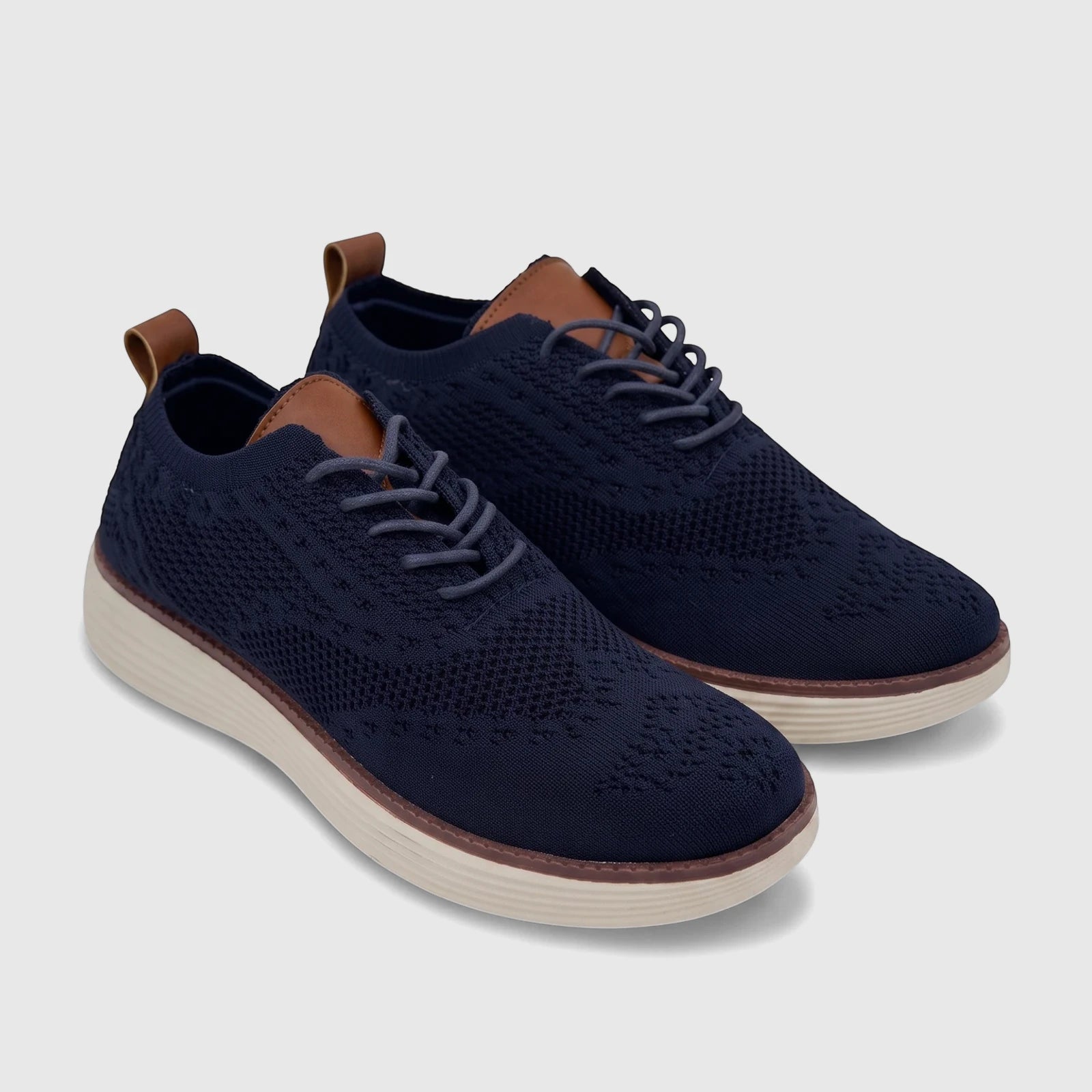 A pair of HP Men's Comfort Sneakers in navy flyknit material, with brown leather accents and light beige soles.