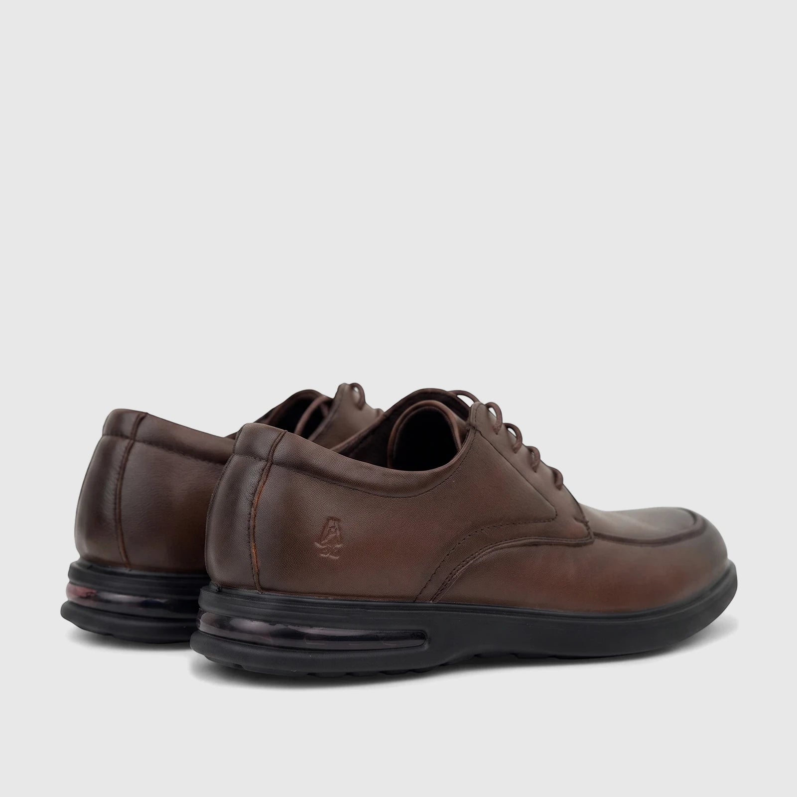 Rear-quarter view of HP Men's Dress Lace Up Patrick shoes in brown leather with black soles and air cushioning.