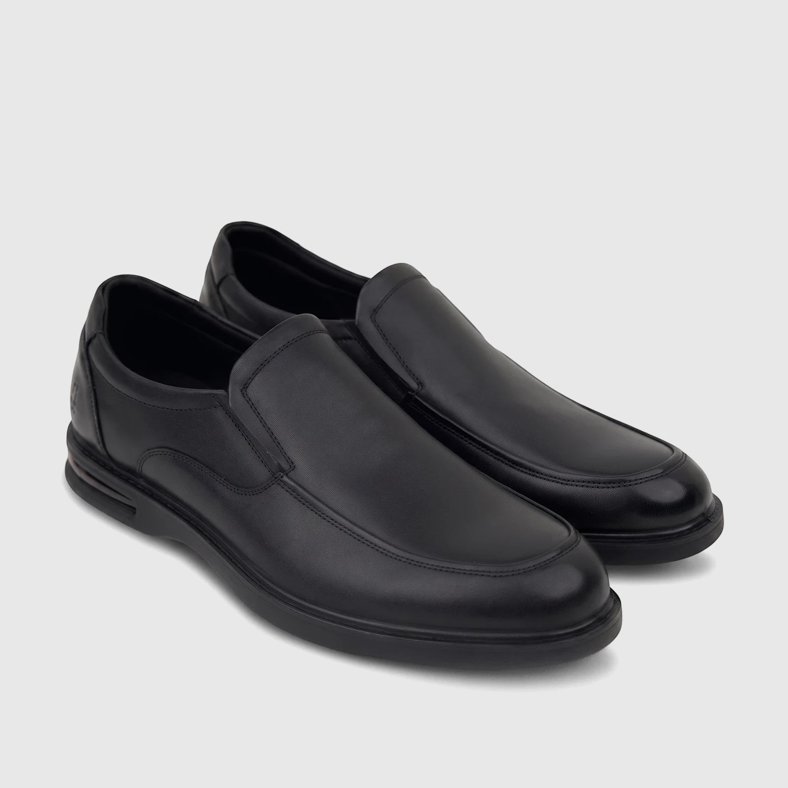 A pair of sleek black leather HP Men's Dress Slip On Julian shoes, featuring detailed stitching and a comfortable design,