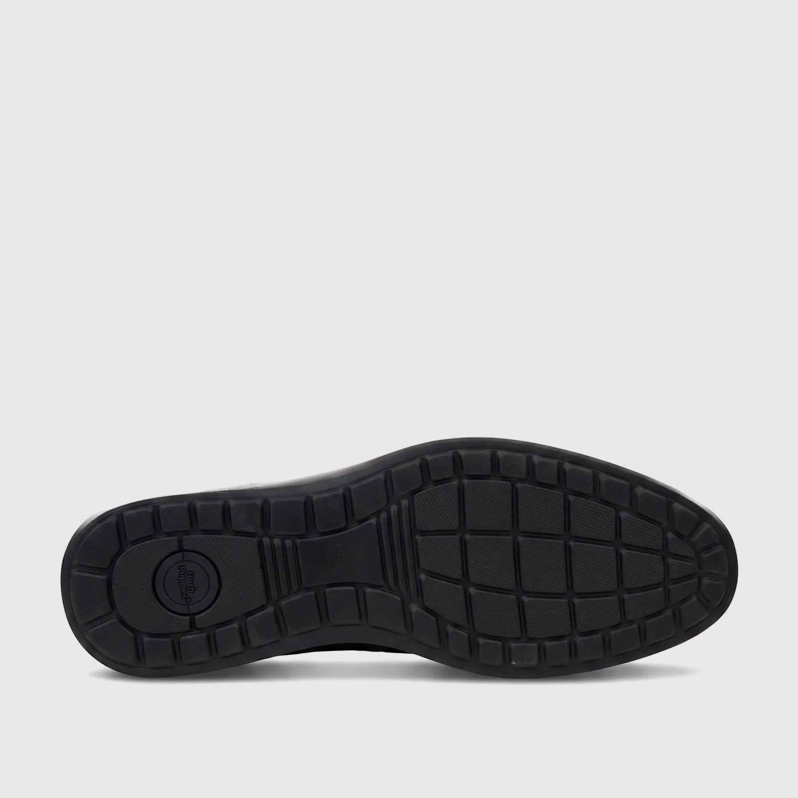 Black HP Men's Dress Slip On Julian shoe sole, showing the textured rubber bottom and Hush Puppies logo from a low-angle
