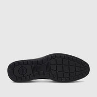 Black HP Men's Dress Slip On Julian shoe sole, showing the textured rubber bottom and Hush Puppies logo from a low-angle