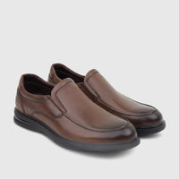A pair of HP Men's Julian HPM01022 brown leather slip-on dress shoes, featuring a sleek design and comfortable fit.