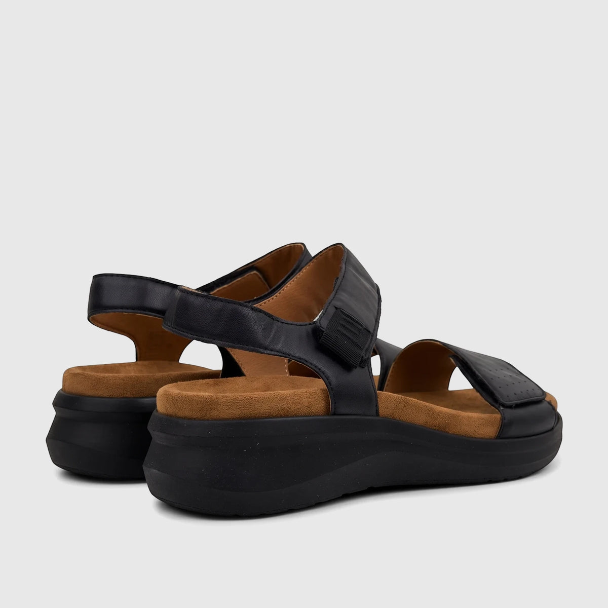 Pair of black HP Saria comfort sandals with platform soles, featuring adjustable hook-and-loop straps and a brown footbed.