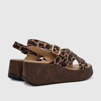 Pair of women's HP Soft Style Jemma leopard print comfort wedge sandals with dark wood-look platforms and gold buckles.