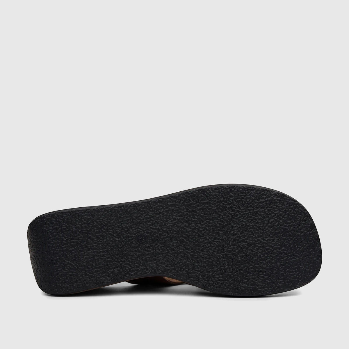 Underside view of an HP Soft Style Jemma black leopard print wedge sandal, featuring a textured black sole and dark brown