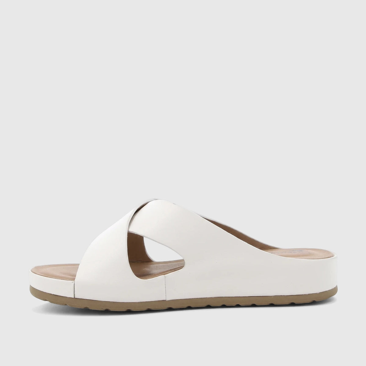 White HP Soft Style Tanika ladies comfort slide sandal with asymmetrical strap and platform sole, side view.