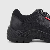 HP Unisex black safety lace-up steel toe shoe, made of textured leather, seen from a side view showcasing the heel and Hush