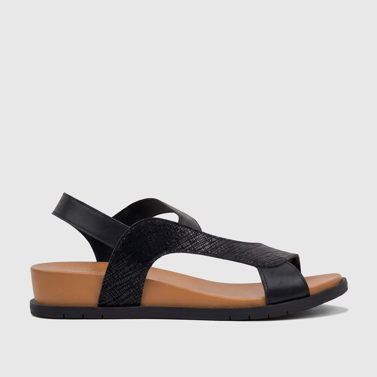 HP Zaira women's comfort sandal in black and brown, featuring a textured upper strap and a comfortable wedge sole, shown in