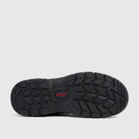 Black Hush Puppies Boulder steel toe safety boot sole with prominent deep tread pattern and red logo, viewed from below.