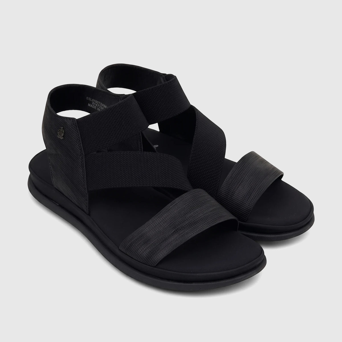 Pair of Hush Puppies Soft Style Ladies Comfort Sandals in black, featuring woven elastic straps and a flat sole.
