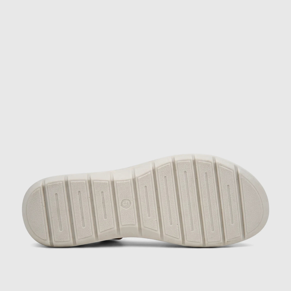 Light gold Hush Puppies Soft Style Ladies Comfort Sandal, bottom view, showcasing its ribbed sole pattern with a molded '5'
