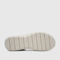Light gold Hush Puppies Soft Style Ladies Comfort Sandal, bottom view, showcasing its ribbed sole pattern with a molded '5'