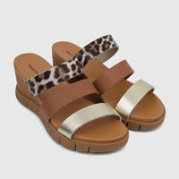 Pair of Hush Puppies Ladies Comfort Wedge Sandals with leopard print, brown, and gold straps, and a brown wedge sole.