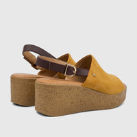 Pair of Hush Puppies Soft Style Ladies Comfort Wedge Sandals in yellow with brown ankle straps and textured tan heels.