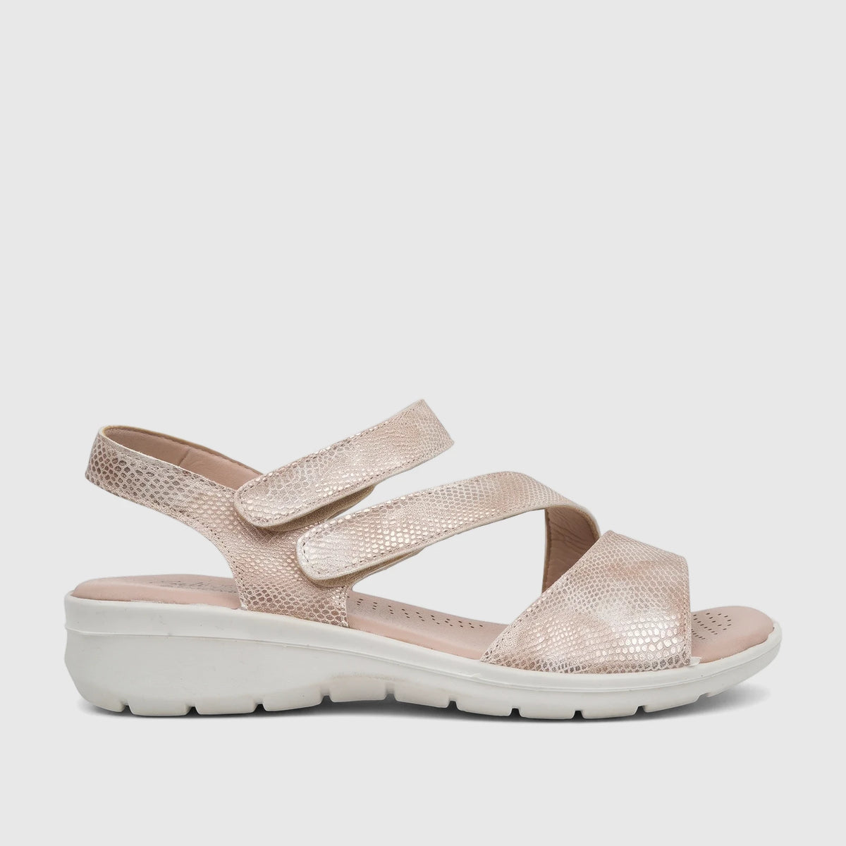Light gold Hush Puppies Soft Style ladies comfort sandal with textured straps and a white sole, shown in side profile.