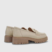 Pair of light sage Hush Puppies Soft Style Lizbeth loafers with chunky brown lug soles, viewed from the rear-right side.