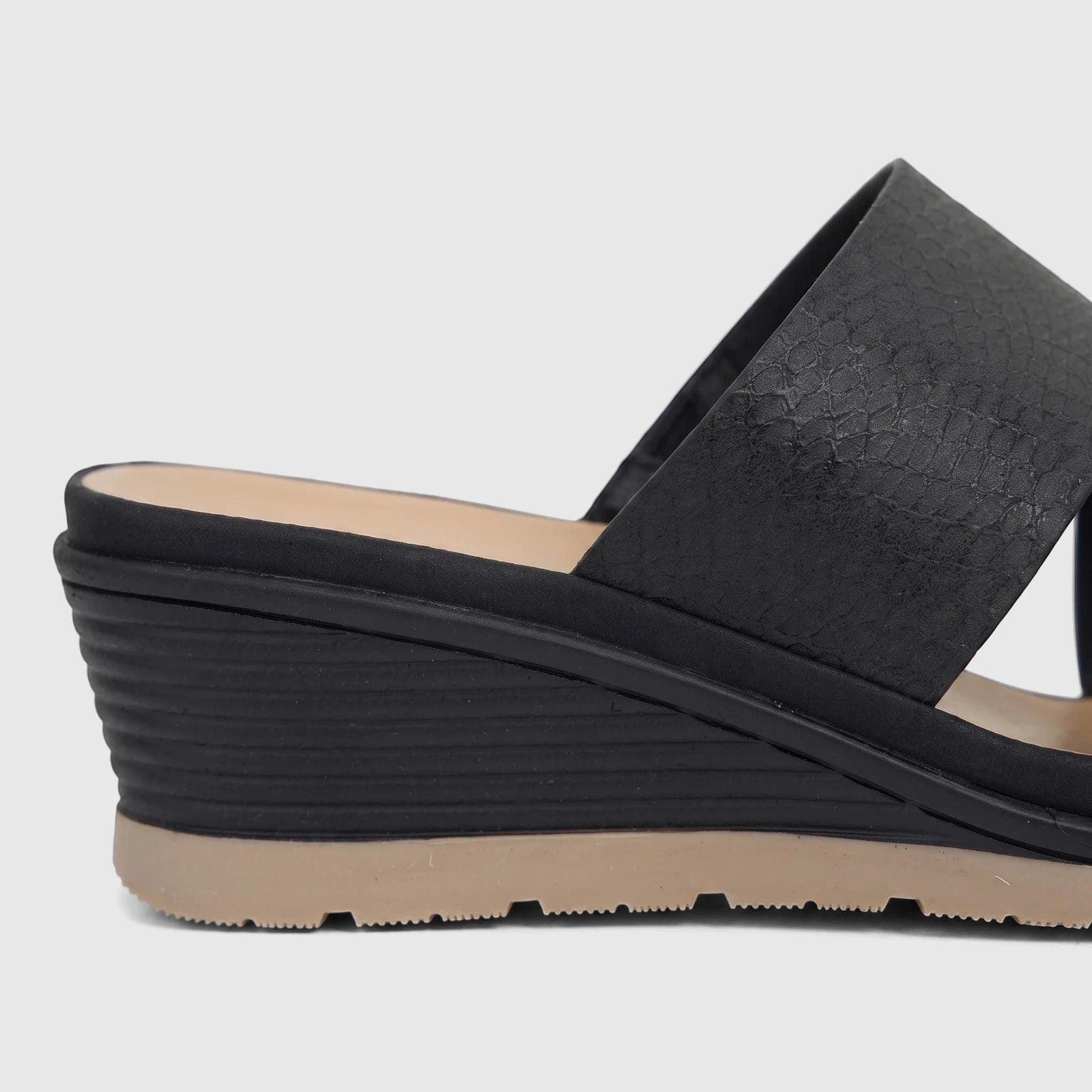 Hush Puppies Soft Style Ladies Comfort Sandal, Posha, in black with textured criss-cross straps and a wedge heel, side view.