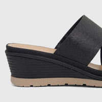 Hush Puppies Soft Style Ladies Comfort Sandal, Posha, in black with textured criss-cross straps and a wedge heel, side view.