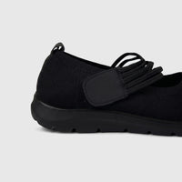 Hush Puppies Soft Style Soft Bartan ladies comfort pump in black with textured knit upper and elastic strap, side view.