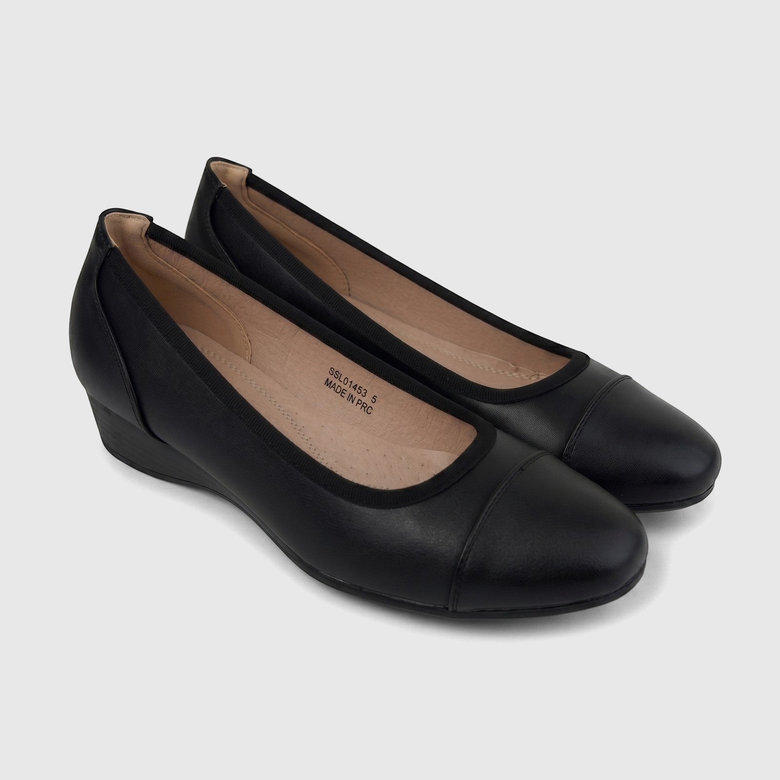 A pair of black Hush Puppies Soft Style Ladies Comfort Wedge Pumps, shown from an elevated side angle.