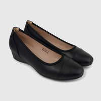 A pair of black Hush Puppies Soft Style Ladies Comfort Wedge Pumps, shown from an elevated side angle.